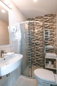 a bathroom with a shower and a sink and a toilet at Brother House Kaunas in Kaunas +77 photos