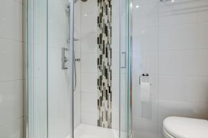 a glass shower in a bathroom with a toilet at Admiral Hotel at Park Avenue in London +82 photos