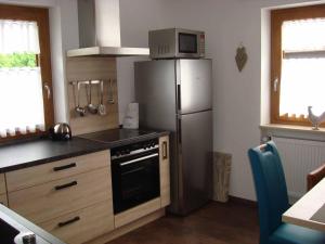 a kitchen with a refrigerator and a microwave at Ferienwohnung Gabi in Piding