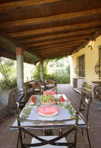 a table with a plate of fruit on a patio at Villa Scozilia in Piedimonte Etneo