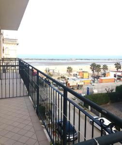 a balcony with a view of the beach at Hotel Alcazar in Rimini