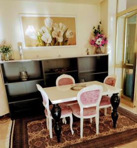 a dining room with a white table and chairs at Hotel Alcazar in Rimini