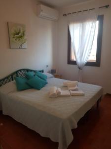 Ένα ή περισσότερα κρεβάτια σε δωμάτιο στο Sa Jaga Brujada Residence - Simar Vacanze