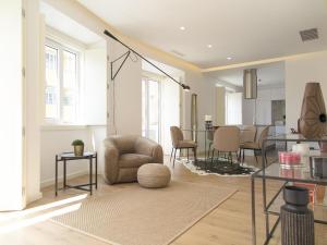 a living room with a chair and a table at Eduardo vii park great bright apt with ac elevator in Lisbon