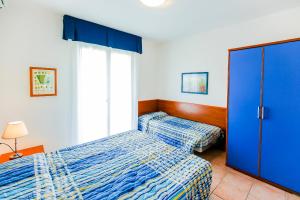 Postel nebo postele na pokoji v ubytování Pioppi Lido Altanea