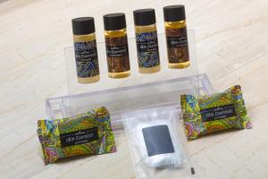 a plastic container with three bottles of essential oils and a bag at Amalia Hotel Delphi in Delfoi