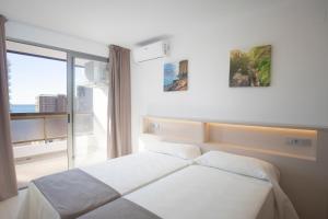 a hotel room with a bed and a window at Aparthotel BCL Levante Club in Benidorm