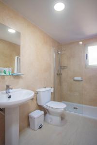 a bathroom with a toilet and a sink and a shower at Aparthotel BCL Levante Club in Benidorm
