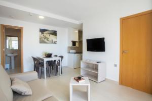 a living room with a couch and a table at Aparthotel BCL Levante Club in Benidorm