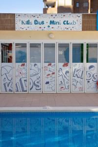 a building with graffiti on the side of a swimming pool at Aparthotel BCL Levante Club in Benidorm