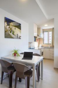 a kitchen with a table with a laptop on it at Aparthotel BCL Levante Club in Benidorm
