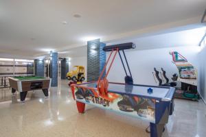 a play room with a pool table and a game at Aparthotel BCL Levante Club in Benidorm