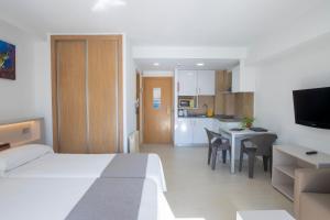 a hotel room with a bed and a kitchen at Aparthotel BCL Levante Club in Benidorm