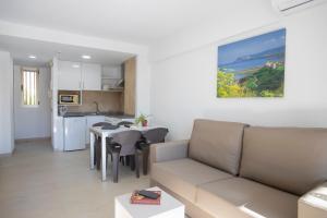 a living room with a couch and a table at Aparthotel BCL Levante Club in Benidorm
