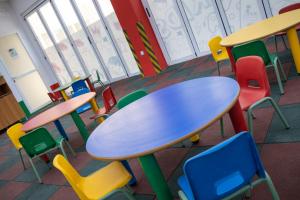 a classroom with a table and colorful chairs at Aparthotel BCL Levante Club in Benidorm
