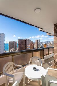 a balcony with two chairs and a table and a view at Aparthotel BCL Levante Club in Benidorm