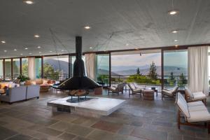 a large living room with a fireplace in the middle at Amalia Hotel Delphi in Delfoi
