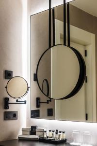 a bathroom with a mirror and a sink at Soho Boutique Catedral in Seville +57 photos