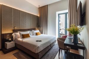 a hotel room with a large bed and a large window at Soho Boutique Catedral in Seville