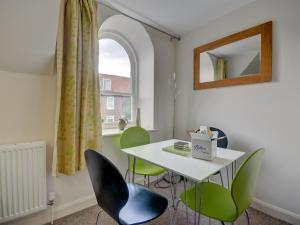 a room with a table and chairs and a window at The Old Auction Rooms Lot 2 Central with Private Parking in Whitby