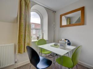 a room with a table and chairs and a window at The Old Auction Rooms in Whitby