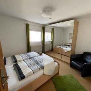 a bedroom with a large bed and a mirror at Ferienwohnung Anke Kaufmann in Miltenberg