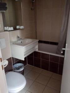a bathroom with a sink and a tub and a toilet at Auberge de Barnas in Barnas +34 photos