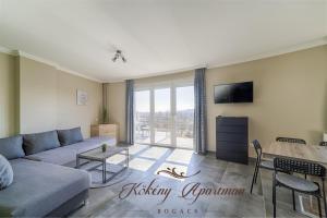 a living room with a couch and a table at Kökény Apartman Bogács in Bogács