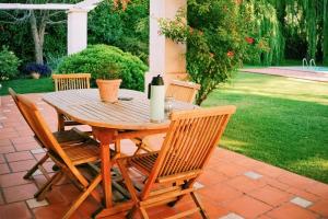Une table et des chaises en bois sont disponibles sur la terrasse. dans l'établissement Casona Medrano, à Luján de Cuyo