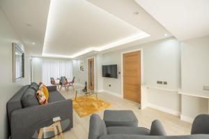a living room with a couch and a table at Headley House in Reading