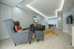 a living room with two chairs and a couch at Headley House in Reading