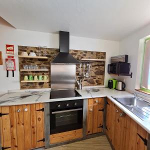 a kitchen with a stove and a sink at Casa Clara in Odeceixe