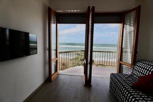a living room with a view of the ocean at Gabbiano 5 in San Vincenzo