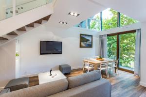 a living room with a couch and a table at Lapwing Residence Sopot in Sopot