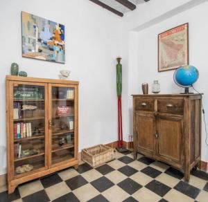 a room with a wooden cabinet and a globe on a floor at APARTAMENTO LA MODERNA in Cádiz