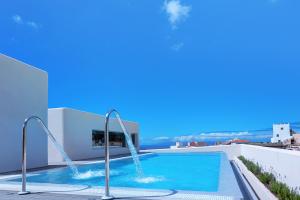 a swimming pool with two water fountains on a building at Alse Homes Adeje in Adeje