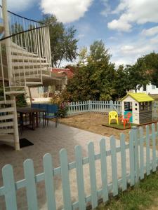 a playground with a white picket fence at le four à pain in Faverolles