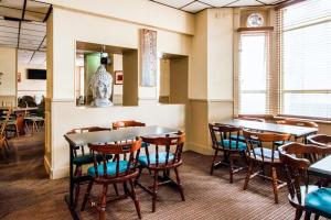 a dining room with tables and chairs at Cardiff Riverside Hotel by Belvilla in Cardiff