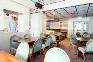 a dining room with wooden tables and chairs at OYO Flagship Cardiff Central in Cardiff