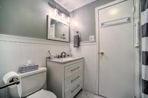 a bathroom with a toilet and a sink and a mirror at Hot Tub Secluded Hideaway on Sleepy Hollow Lake in Athens +26 photos