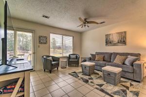 a living room with a couch and a tv at Quaint Hot Springs Condo on Lake Hamilton! in Hot Springs