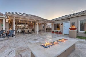 a patio with a fire pit in front of a house at Modern Sun City Studio Near Deer Valley Golf in Sun City West