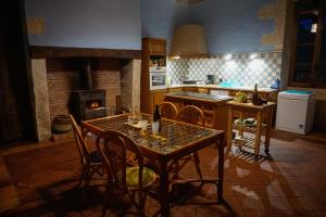a kitchen with a table and chairs and a stove at Chambres d'hôte en Dordogne in Beauronne