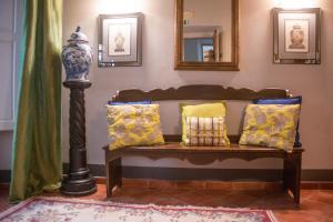 a bench with pillows on it in a room at Antica Dimora De' Benci in Florence