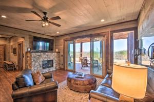 a living room with leather furniture and a fireplace at Luxurious Mountain Getaway with Game Room and Hot Tub! in Mineral Bluff