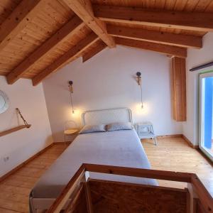 a bedroom with a bed and a large window at Casa Clara in Odeceixe