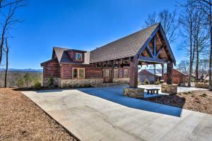 a log house with a pavilion in front of it at Luxurious Mountain Getaway with Game Room and Hot Tub! in Mineral Bluff
