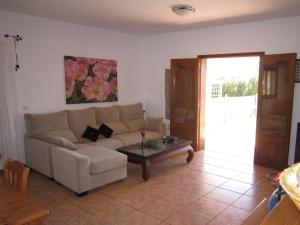 
a living room with a couch and a table at Villa Es Cubells 204 in Es Cubells
