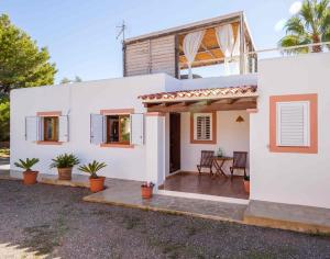 a white house with a patio in front of it at Villa Es Cubells 204 in Es Cubells