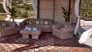 a patio with two couches and a table at Villa Es Cubells 204 in Es Cubells